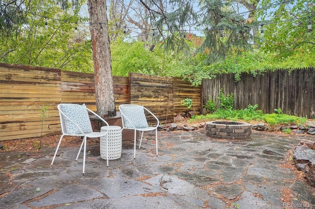 5405 S Lowell Blvd, Littleton, CO 80123 - view of patio / terrace featuring an outdoor fire pit and a fenced backyard