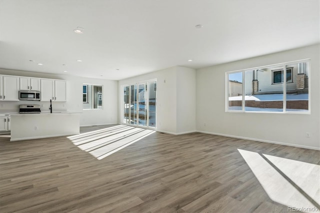 unfurnished living room with light wood-type flooring