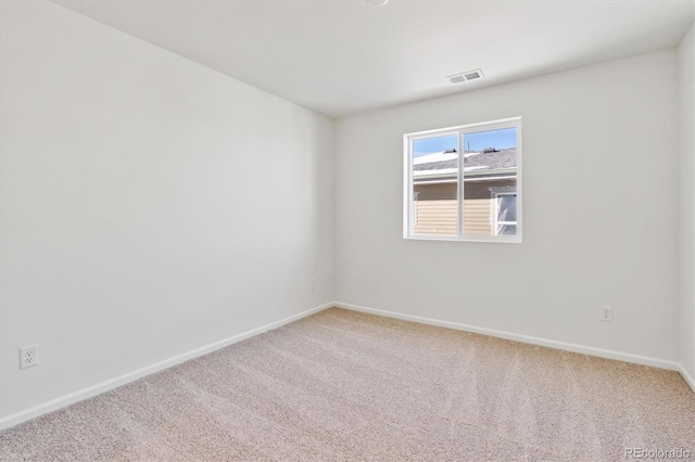 spare room featuring carpet