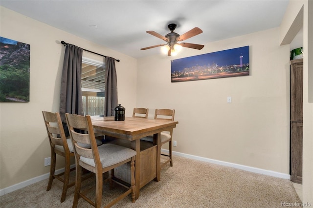 carpeted dining area featuring ceiling fan