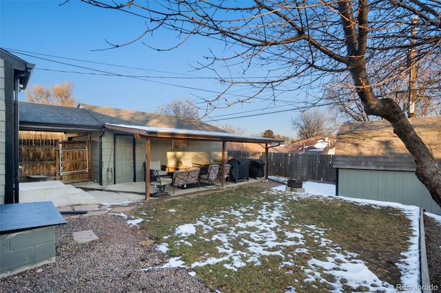 yard covered in snow featuring a patio area