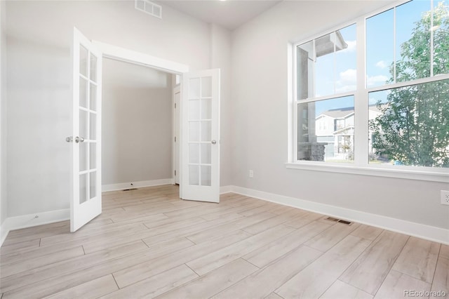20968 E 60th Pl, Aurora, CO 80019 - spare room with french doors, healthy amount of natural light, and light wood finished floors
