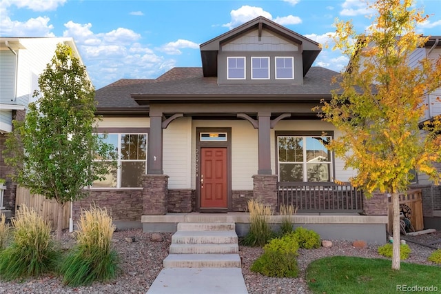 20968 E 60th Pl, Aurora, CO 80019 - craftsman-style home with a porch, roof with shingles, and stone siding