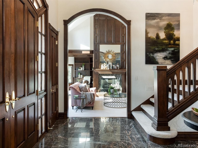1189 Rembrandt Rd, Boulder, CO 80302 - entrance foyer featuring dark marble finish flooring, stairway, and arched walkways