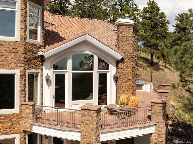 1189 Rembrandt Rd, Boulder, CO 80302 - view of home's exterior featuring exterior kitchen, stone siding, a balcony, and stucco siding