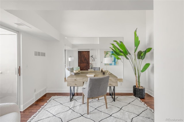 office featuring baseboards, visible vents, and wood finished floors