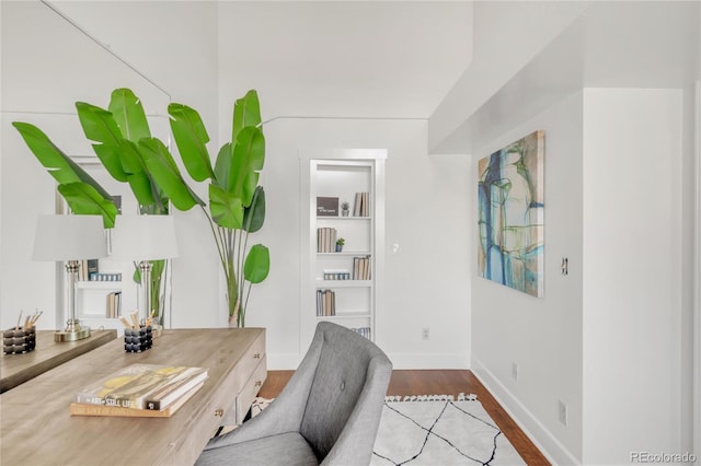 office featuring baseboards and wood finished floors