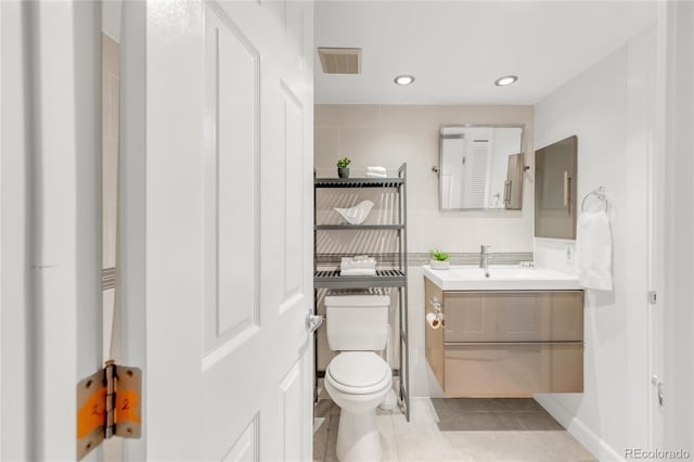 bathroom with visible vents, toilet, tile patterned flooring, vanity, and recessed lighting