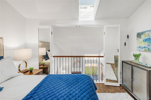 bedroom featuring a textured ceiling and wood finished floors