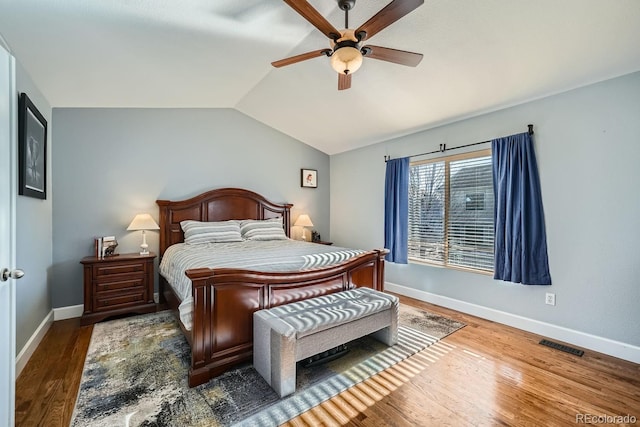 bedroom featuring dark wood-type flooring, ceiling fan, and vaulted ceiling