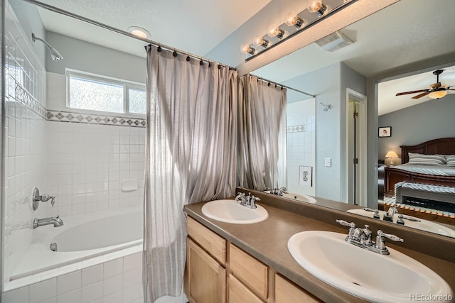 bathroom featuring ceiling fan, vanity, and shower / bathtub combination with curtain