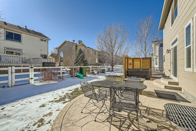 snow covered patio featuring a hot tub