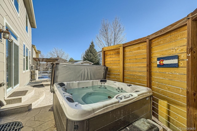 view of patio / terrace featuring a hot tub and a pergola