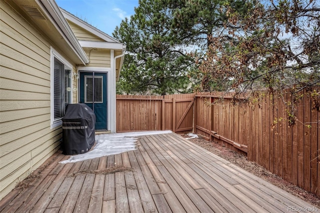deck with a fenced backyard and area for grilling