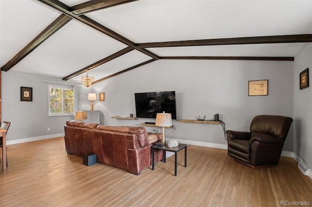 living room with lofted ceiling with beams and light hardwood / wood-style floors