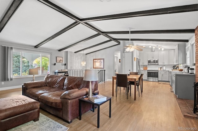 living room with light wood-type flooring, vaulted ceiling with beams, and ceiling fan