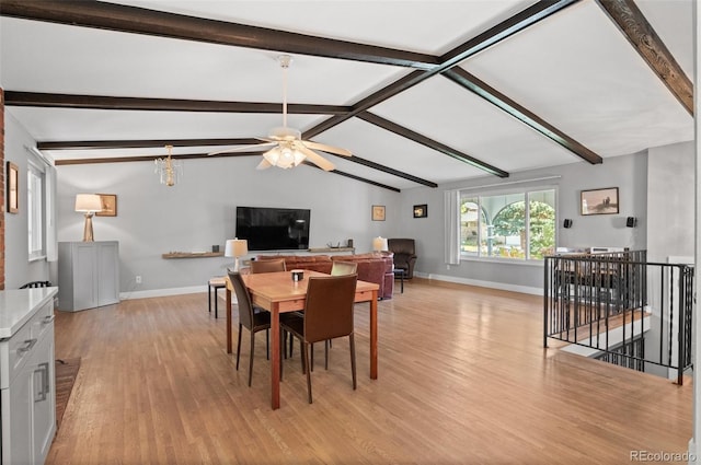 dining space featuring ceiling fan, lofted ceiling with beams, and light hardwood / wood-style flooring