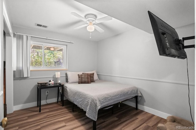 bedroom with ceiling fan and hardwood / wood-style flooring