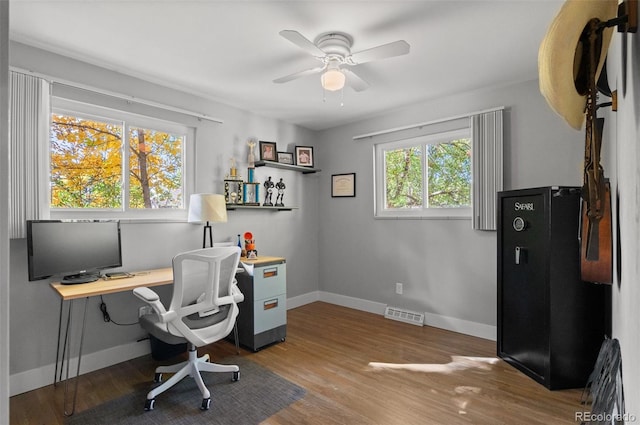 office with wood-type flooring and ceiling fan