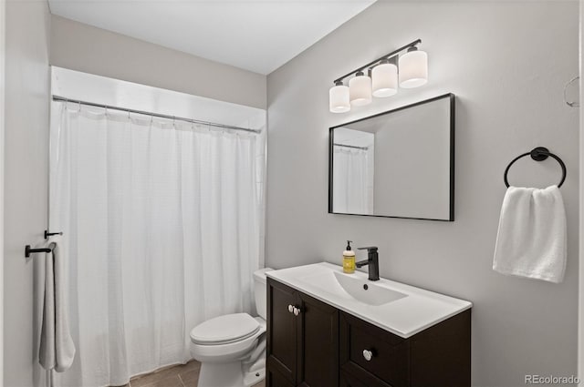 bathroom featuring walk in shower, vanity, toilet, and tile patterned flooring