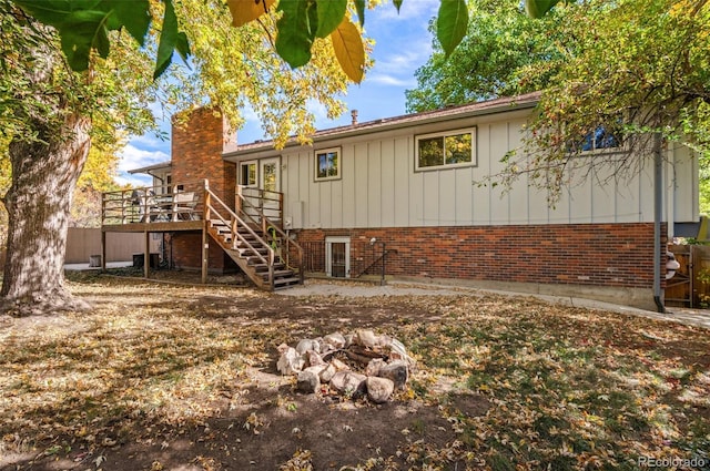 rear view of house featuring a wooden deck