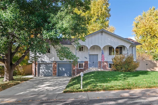 view of front of home with a front yard and a garage