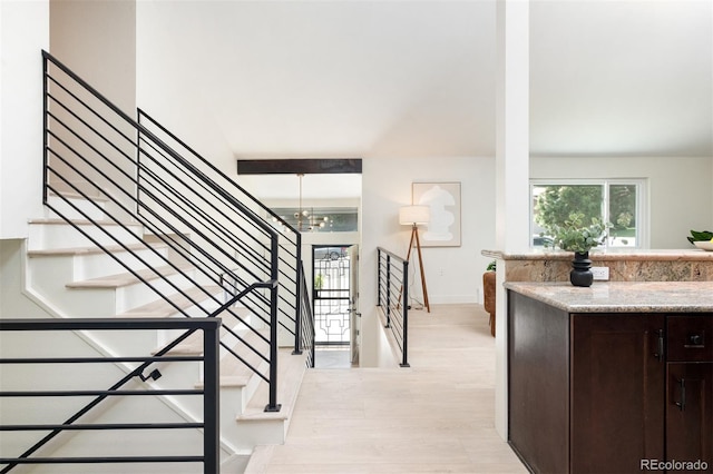 7453 E Jefferson Dr, Denver, CO 80237 - stairs featuring wood finished floors and a chandelier