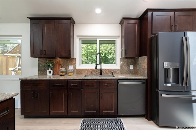7453 E Jefferson Dr, Denver, CO 80237 - kitchen with stainless steel appliances, backsplash, dark brown cabinetry, light stone counters, and recessed lighting