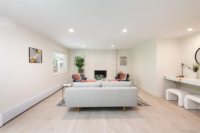 7453 E Jefferson Dr, Denver, CO 80237 - living room with light wood-style flooring, a tiled fireplace, and recessed lighting