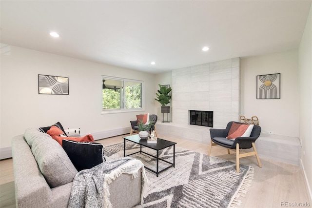 7453 E Jefferson Dr, Denver, CO 80237 - living room with recessed lighting, a tiled fireplace, and wood finished floors