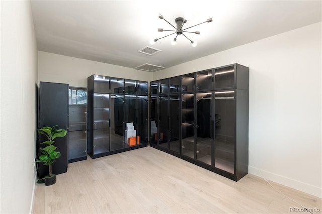 7453 E Jefferson Dr, Denver, CO 80237 - spacious closet featuring light wood finished floors and a chandelier