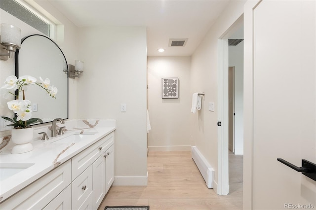 7453 E Jefferson Dr, Denver, CO 80237 - bathroom with double vanity, wood finished floors, and recessed lighting