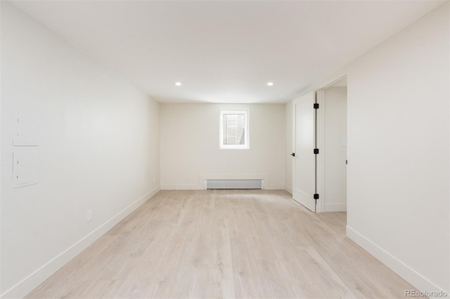 7453 E Jefferson Dr, Denver, CO 80237 - empty room with a baseboard heating unit, light wood-style floors, and recessed lighting