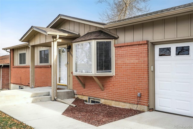 view of exterior entry featuring a garage and central AC unit