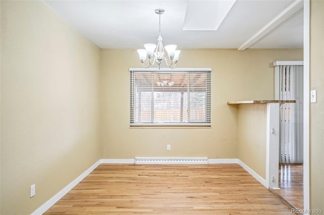 unfurnished dining area with baseboard heating, light hardwood / wood-style flooring, and an inviting chandelier