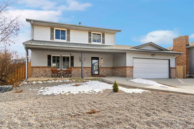 traditional-style home featuring driveway, an attached garage, covered porch, fence, and brick siding