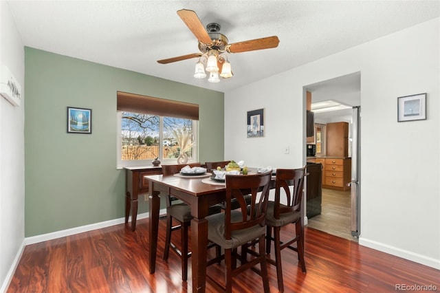 dining room with ceiling fan, wood finished floors, and baseboards