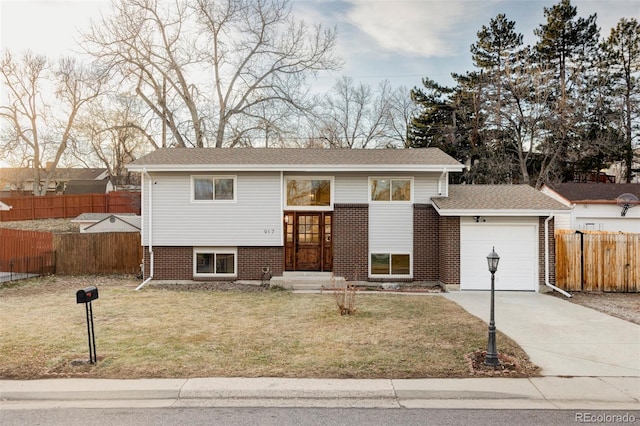 split foyer home with a garage and a front lawn