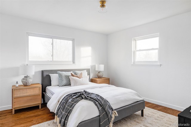 bedroom featuring hardwood / wood-style flooring and multiple windows