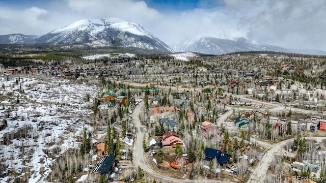 snowy aerial view featuring a mountain view
