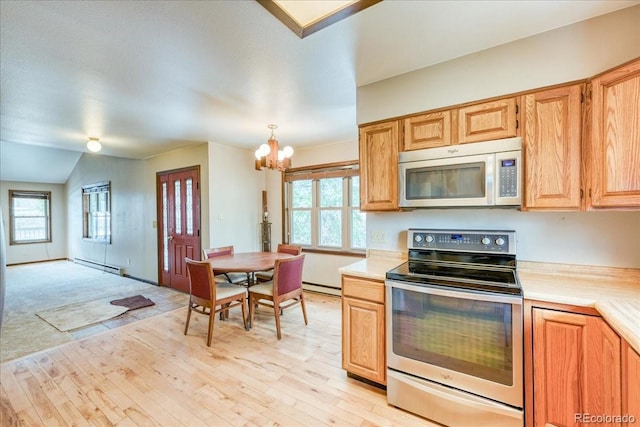 kitchen featuring an inviting chandelier, baseboard heating, light countertops, a baseboard heating unit, and appliances with stainless steel finishes