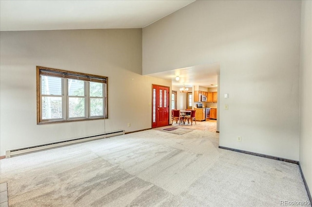 carpeted living room with an inviting chandelier, high vaulted ceiling, baseboards, and baseboard heating