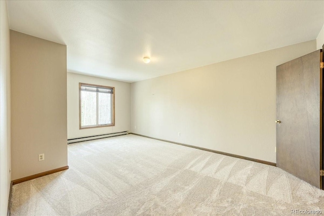 carpeted spare room featuring baseboards and a baseboard heating unit