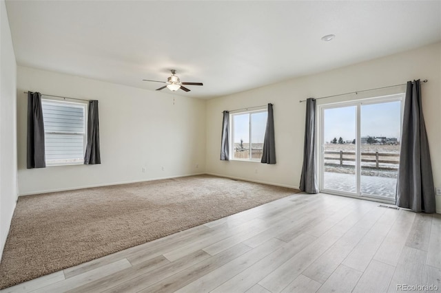 spare room featuring ceiling fan and light wood-type flooring