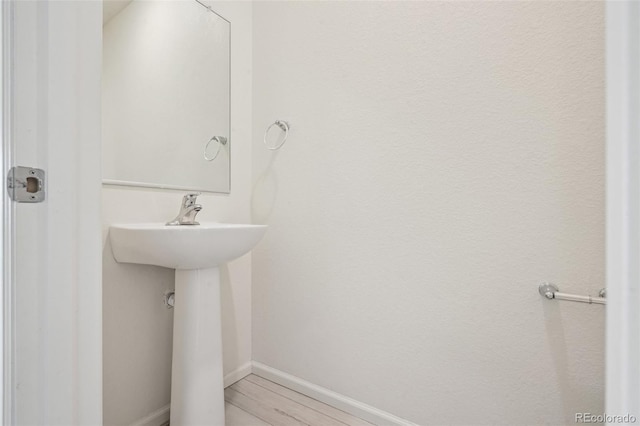 bathroom with hardwood / wood-style floors