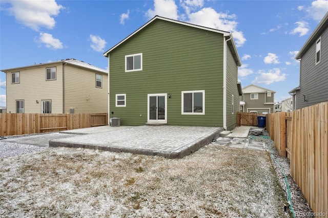 back of property with central AC and a patio area