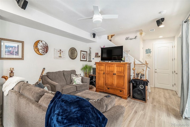 living room featuring ceiling fan and light wood-type flooring