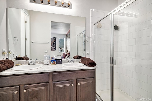 bathroom with walk in shower and vanity