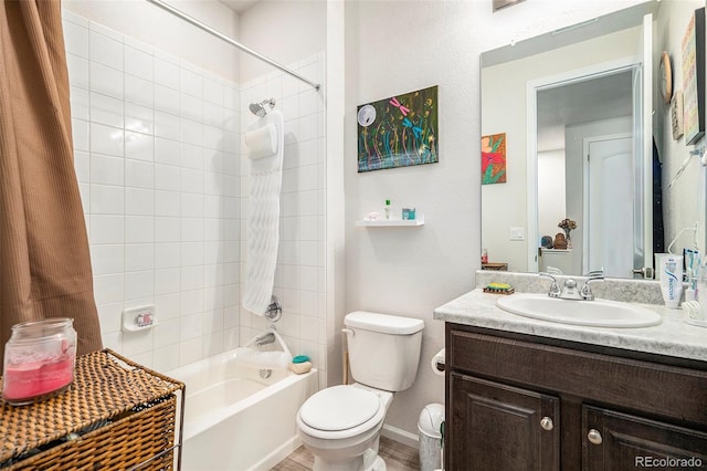 full bathroom featuring toilet, vanity, and tiled shower / bath