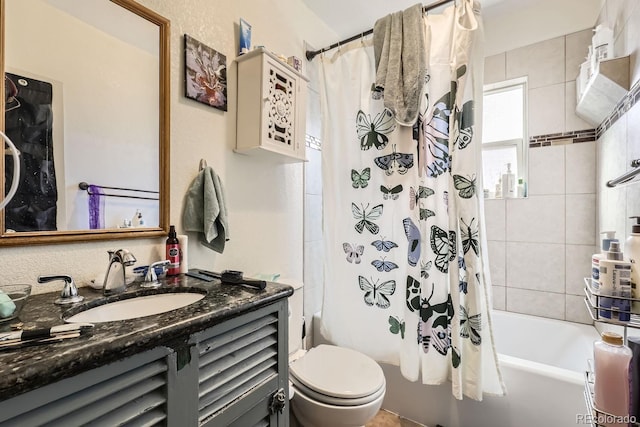 bathroom featuring toilet, shower / tub combo, a textured wall, and vanity